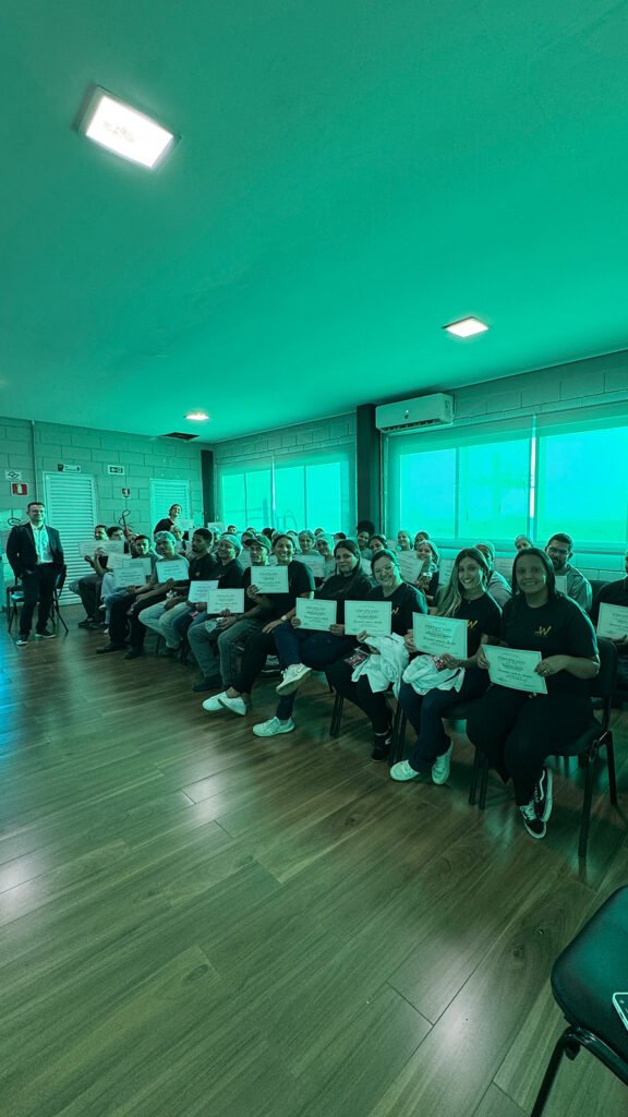Guilherme Biotto com colaboradores da W Cosméticos da cidade de Boituva SP segurando certificados de participação na palestra sobre funcionamento e controle da ansiedade